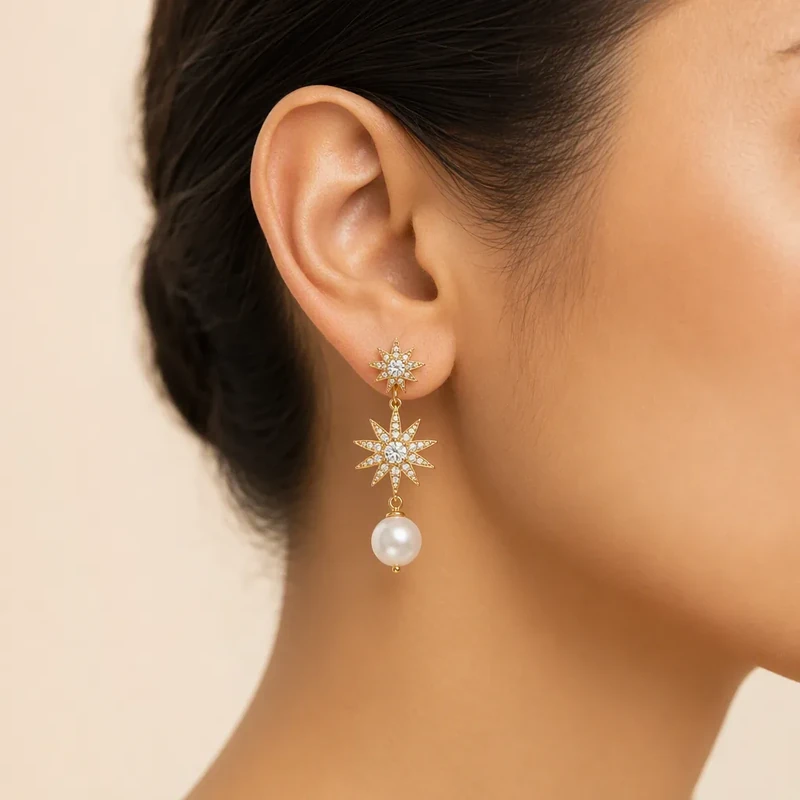 Pearl drop earrings worn on an ear